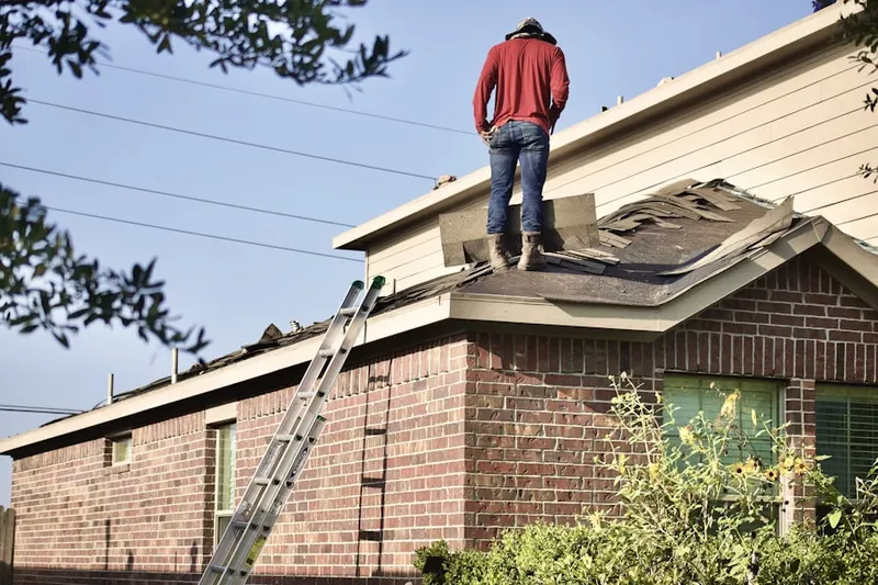 Professional roofer working on a residential roof in Strasburg